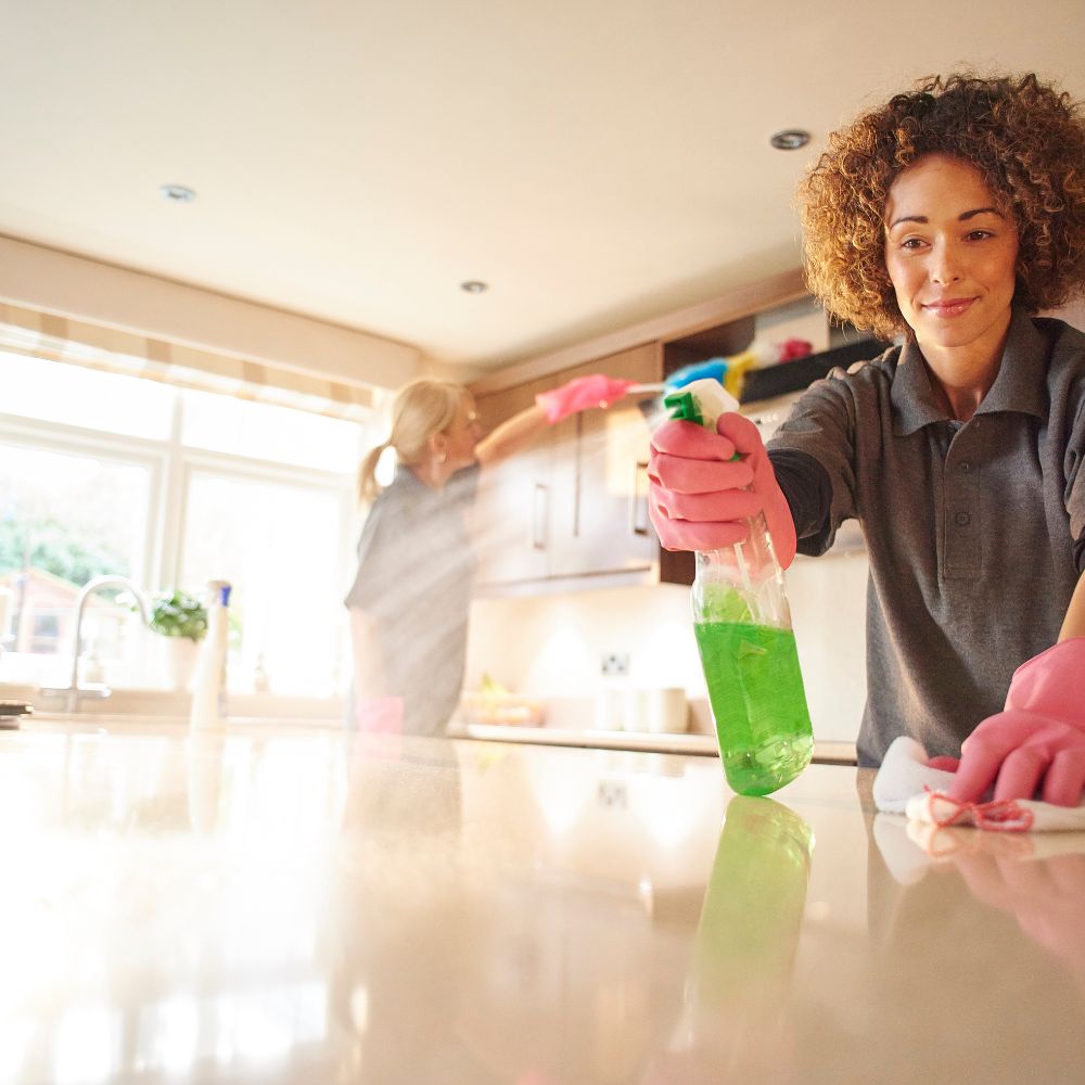 Professional cleaner from Direct Outlet Cleaning performing detailed house cleaning.